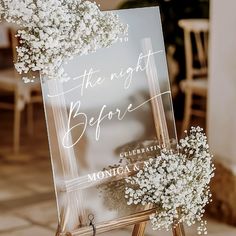 an easel with flowers on it and a sign that says, in the night before