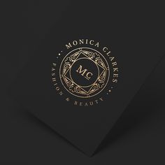 a black and gold business card with the letter m on it's front side