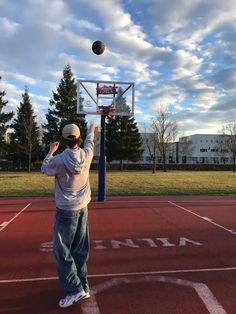 a man standing on top of a basketball court next to a basket ball flying through the air