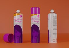 two purple spray cans next to each other on an orange background with the same product in it