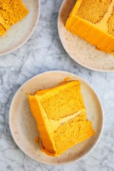 three plates with slices of pumpkin cake on top of each one and the rest of the plate in front of them