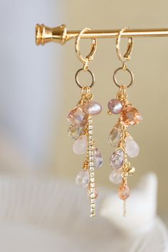 "This beautiful earrings are made from handful of gemstone like Quartz, Amethyst, Amtrine, Rose Quartz, and Pearl in 14K gold filled wires. They are carefully hung on a ring that dangling under a small gold ear hoop. The pictures do not do this earrings justice Let this unique accessory be your everyday adventures or a great gift for the loved one! Because each item is handmade there may be differences from the picture viewed. Each stone/ piece is unique and no two pieces will be exactly alike. Small Gemstone Jewelry, Handmade Stone Earrings, Earring Cluster, Rose Quartz And Pearl, Diy Earrings Dangle, Handmade Dangle Earrings, Gem Earrings, Everyday Adventures, Sparkly Earrings