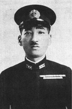 an old black and white photo of a man in uniform