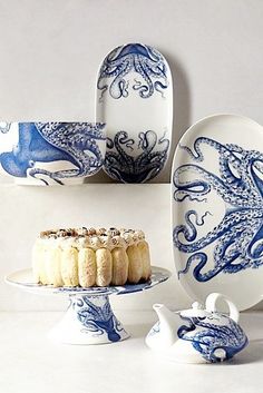 blue and white plates with food on them sitting next to each other in front of a wall