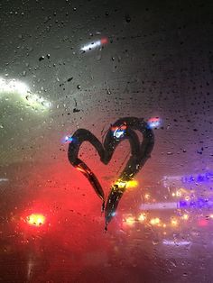 a heart shaped object is seen through the rain