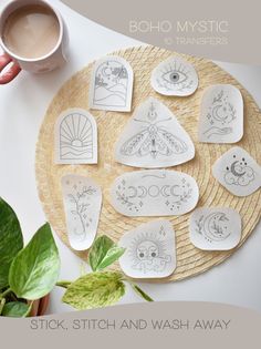 a plate with some drawings on it next to a cup of coffee and plant leaves