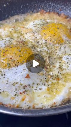 an egg frying in a skillet on top of a stove with spices and seasonings