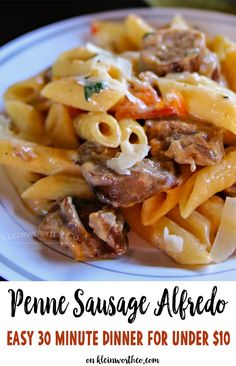 a white plate topped with pasta covered in sauce and meat next to an orange napkin