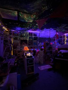 a room filled with lots of clutter and lights on the ceiling in front of it