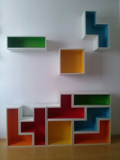 colorful shelves are arranged on the wall