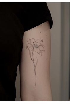 a woman's arm with a flower tattoo on the left side of her body