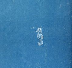 an old book with a sea horse on it's cover and the title in white