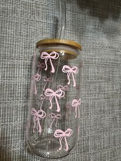 a glass jar with pink bows on it