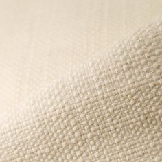 the texture of an upholstered mattress is shown in white and neutral colors, as well as beige linens