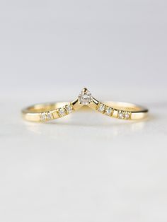 a yellow gold wedding ring with diamonds on it