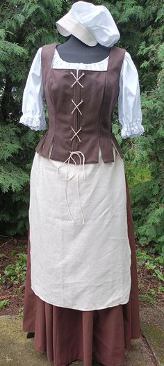 Historical costum or fantasy costum for woman. Under shirt made from White cotton fabric.the blouse is tied at the neck with a cord Round Skirt is made from cotton Fabric. There is a rubberband and cord at the waist. Stays is made from woolen Fabric. Lining is made from white cotton Fabric. the costume also includes a linen apron and a cotton cap. Also costume includes: - shirt - stays - skirt - bonnet - apron This dress will be made to measure. IF YOU PREFER A DIFFERENT COLOR CONTACT ME Please Huterite Dress, Peasant Style Medieval Linen Dress For Larp, Peasant Style Linen Medieval Dress For Larp, Fitted Prairie Dress Costume For Medieval Festivals, Historical Victorian Dress For Larp, Fitted Linen Medieval Dress, Overbust Medieval Dress For Larp With Historical Design, Medieval Prairie Dress For Costume, Medieval Overbust Dress For Medieval Festivals