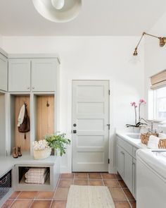 a clean and organized laundry room with lots of storage