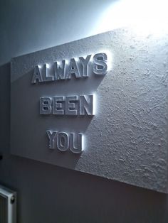 there is a sign that says always been you on the side of a wall in a room