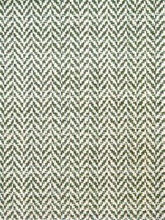 a green and white rug with an interesting pattern