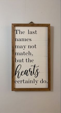 a framed sign that says the last names may not match but the hearts certainly do