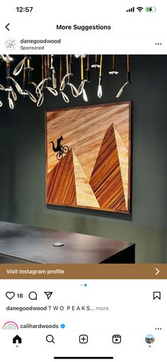 an image of a painting hanging on the wall above a table with chairs in it