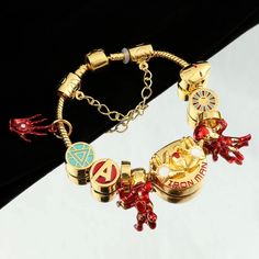 Marvel Universe brings you this exquisite 18k Gold, Silver And Stainless Steel Official Iron Man Unisex Charm Bracelet. Excellent Unisex gift for any age, gender or style type. The gold stainless steel Charms are crafted with extreme attention to every detail, the details Is what makes this charm bracelet One-Of-A-Kind and unique as you will NOT find such beautiful craftsmanship in every inch of ANY CHARM Bracelet In the industry. The Facts: This beautiful Charm Bracelet Won’t Change colors, tur Luxury Gold Metal Bracelet As Gift, Luxury Gold Bracelet As Gift, Yellow Gold Metal Bracelets For Gift, Yellow Gold Metal Bracelets As Gift, Yellow Gold Metal Bracelet For Gift, Gold Hypoallergenic Alloy Jewelry, Luxury Metal Charm Bracelet As A Gift, Gold-tone Stainless Steel Chain Bracelet For Gifts, Alloy Jubilee Bracelet As Gift