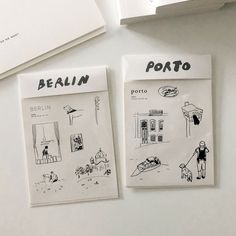 two postcards with drawings on them sitting next to each other