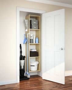 an open closet with various items on the shelves and in front of it is a white door