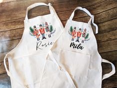 two personalized aprons are sitting on a table