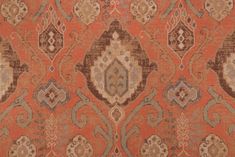 an orange and brown rug with many different designs