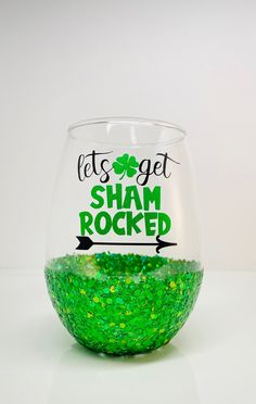 a green glittered wine glass with the words let's get shamrock rocked on it