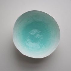 a white and blue bowl sitting on top of a table