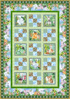 a green quilt with animals and flowers on the border, in front of a blue sky