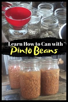 jars filled with beans sitting on top of a wooden table