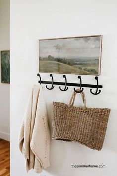 a basket and coat rack hanging on the wall