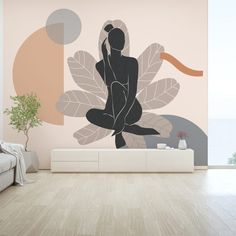 a living room with a couch, coffee table and large wall mural on the wall