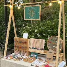 a table with jewelry on it in front of some trees