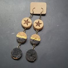 the earrings are made out of cork and have stars on them, hanging from chains