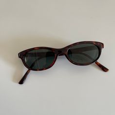 These MINI round oval sunglasses are your everyday classic. Featuring a black frame with black tint lens. This style is unisex. True genuine vintage sunglasses from the 90s.  400 uv  Measurements: frame width: 132mm Lens Height:  29mm Lens Width:   47mm Bridge: 17mm Arm temple: 143mm new vintage includes sunglasses pouch Sunglasses Cat Eye, Sunglasses Pouch, Cheap Sunglasses, Black Rectangle, Tinted Sunglasses, Rectangle Sunglasses, Oval Sunglasses, Vintage Sunglasses, Sunglasses Vintage