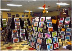 a room filled with lots of framed pictures