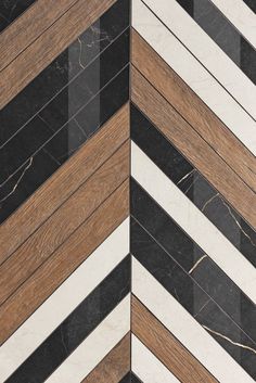 an image of wood and marble flooring that looks like chevrons or stripes