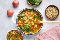 two bowls filled with soup next to some vegetables