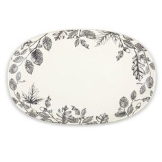 an oval platter with leaves and berries on the rim, in black and white