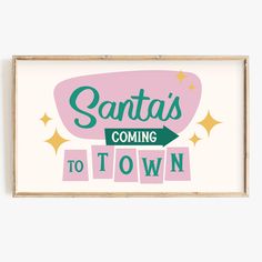 a framed sign that says santa's coming to town