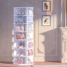 there is a tall white shoe rack with many pairs of shoes on the bottom shelf