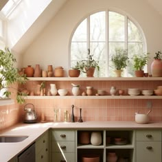 a kitchen filled with lots of pots and pans on top of a window sill