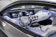 the interior of a mercedes benz s - class coupe is shown with blue lights and steering controls