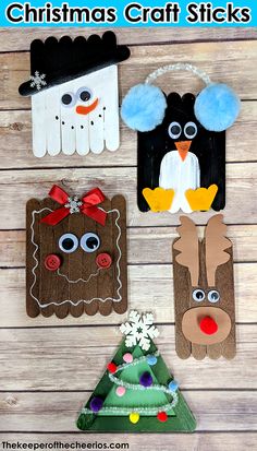 four paper christmas decorations on a wooden table