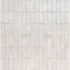 a white tiled wall with no one sitting on the floor or standing in front of it