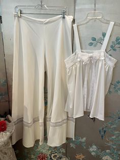 1960's vintage, Original Design, one of a kind, Baby Doll pajamas that could be worn as a outfit. The fabric is white, weighted, polyester jersey with white lace insets and grosgrain ribbon. The palazzo pants are, wonderfully, wide, 40" at hemline! And the top is, oh so, easy to wear. The lace band under the arms and over the bust is 36"(firm; no give) the length from shoulder to hem is 261/2". The waist band on the palazzo pants is 32" with some stretch. Machine wash Vintage Pyjamas, Baby Doll Pajamas, Doll Pajamas, Vintage Loungewear, Bridal Pajamas, Vintage Pajamas, Pyjama Sets, Lace Bands, A Outfit